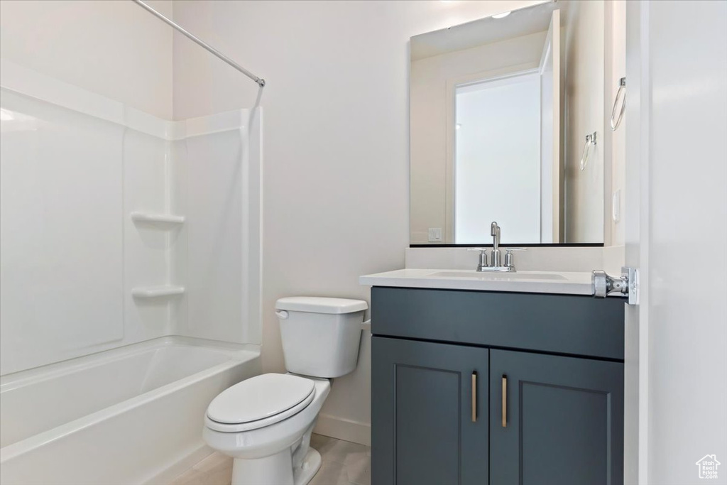 Full bathroom featuring  shower combination, vanity, and toilet
