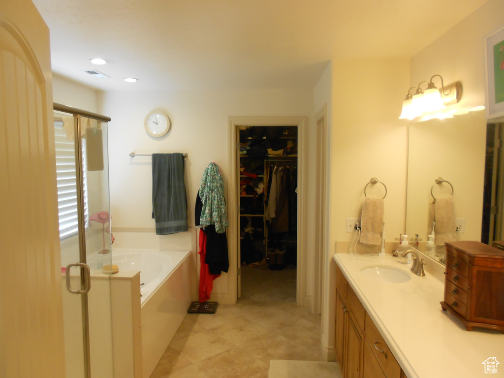 Bathroom featuring plus walk in shower, vanity, and tile floors