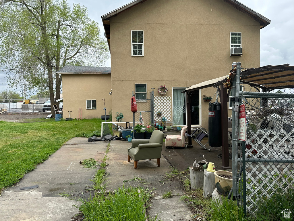 Back of house with a patio, a yard, and an outdoor hangout area