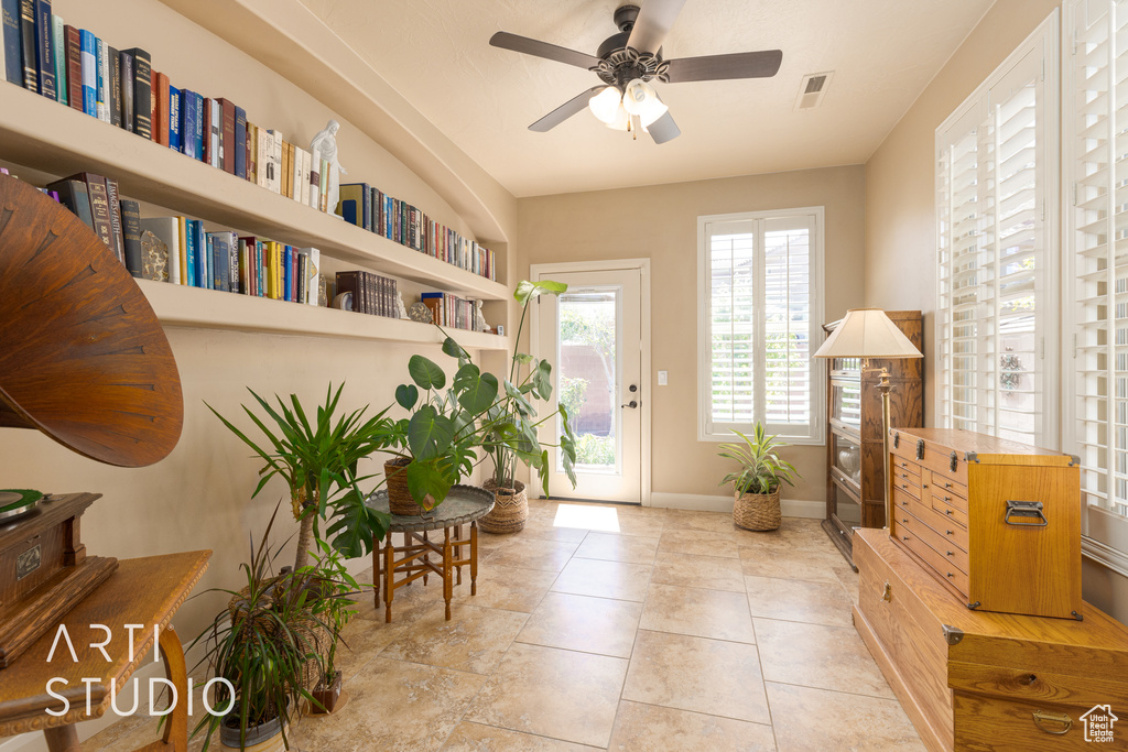 Interior space with ceiling fan and tile flooring