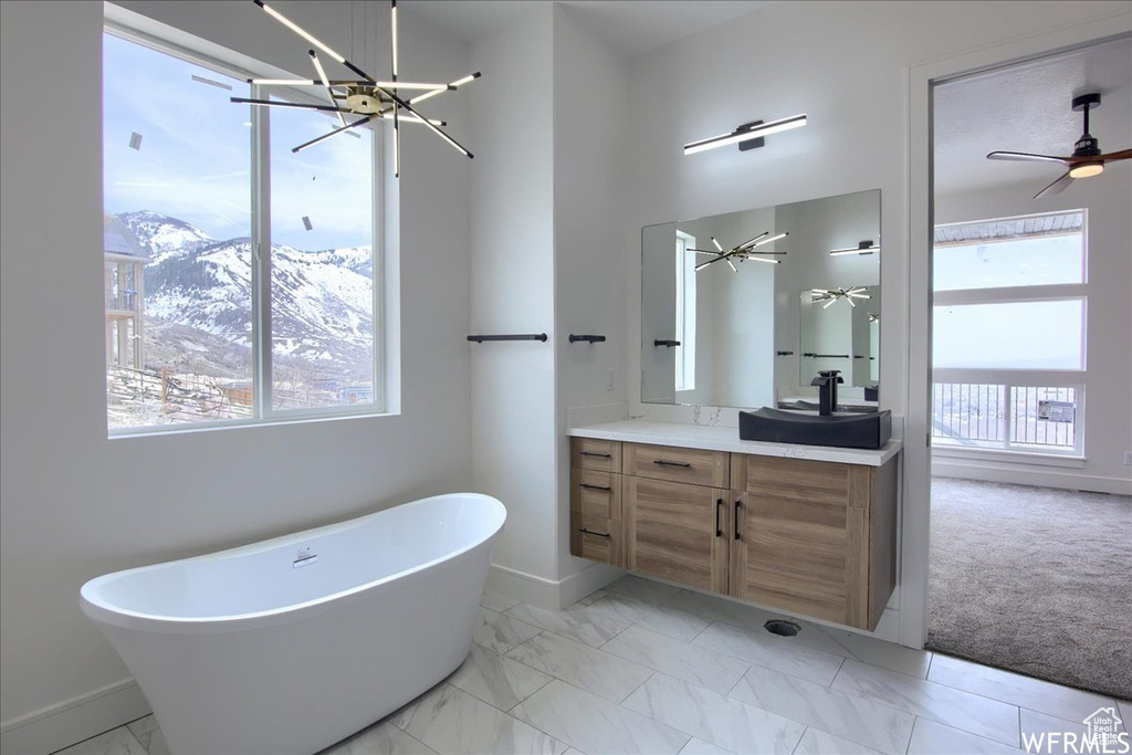 Bathroom featuring oversized vanity, tile floors, and plenty of natural light
