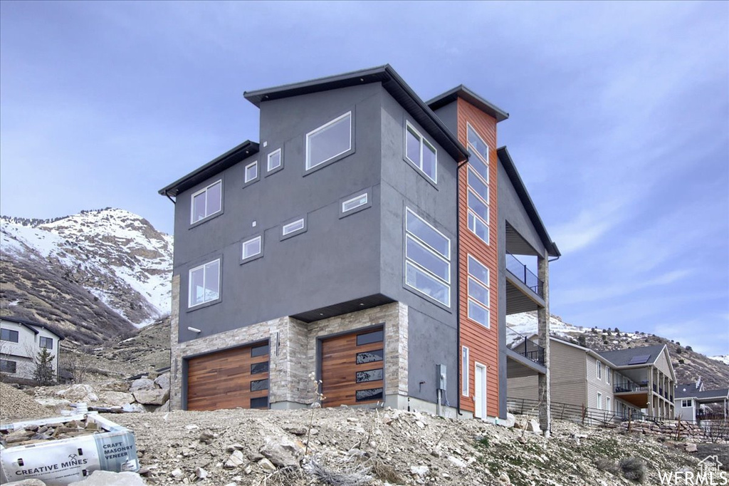 Exterior space with a mountain view and a garage