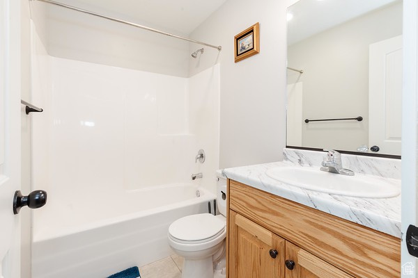 Full bathroom featuring tile floors, oversized vanity, bathtub / shower combination, and toilet
