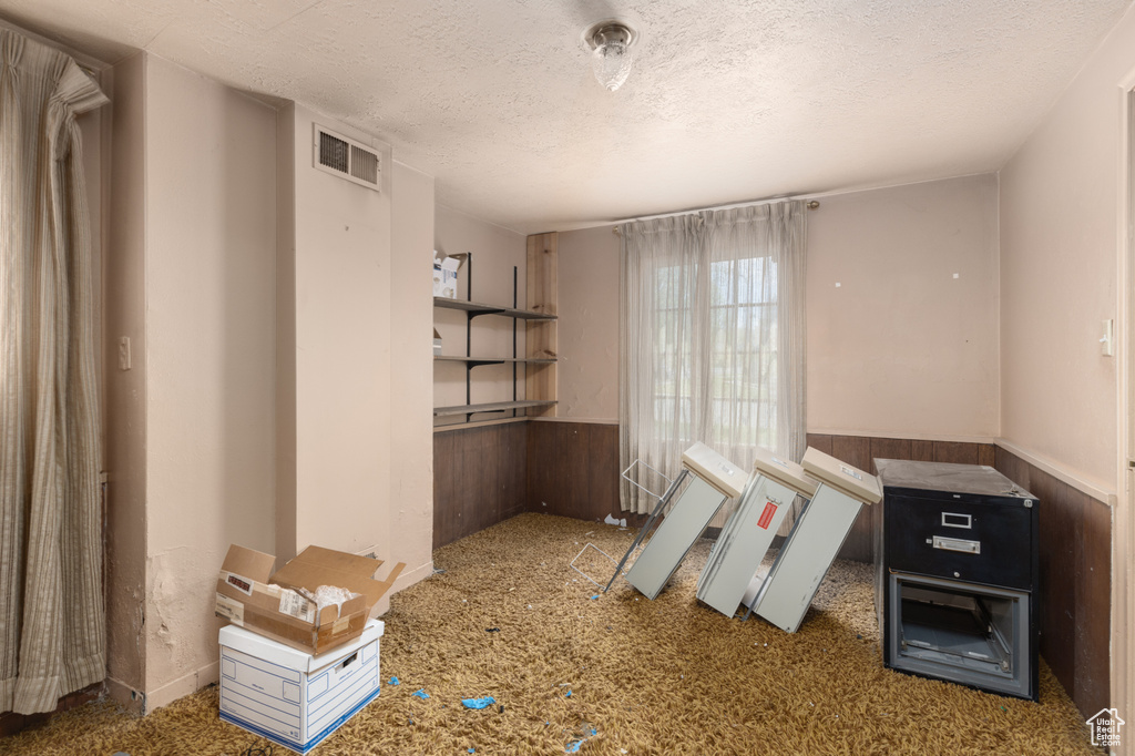 Miscellaneous room featuring a textured ceiling