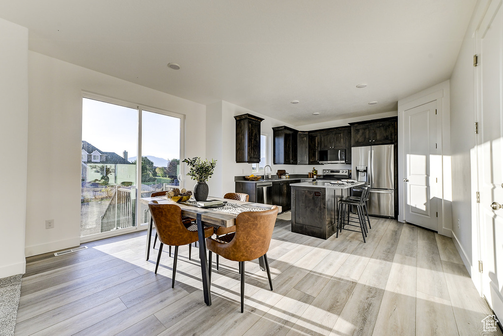 Dining room featuring sink and light hardwood / wood-style floors