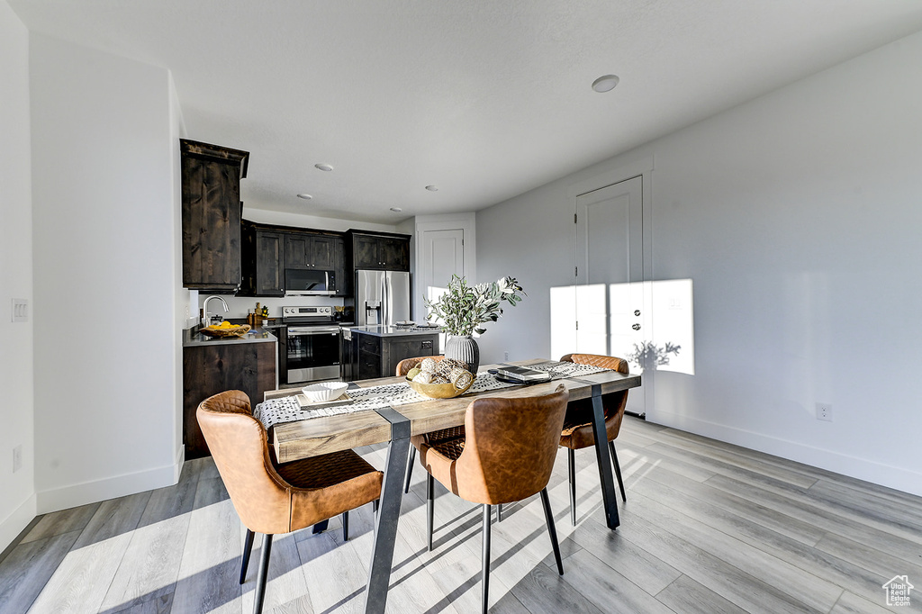 Dining space featuring sink and light hardwood / wood-style floors