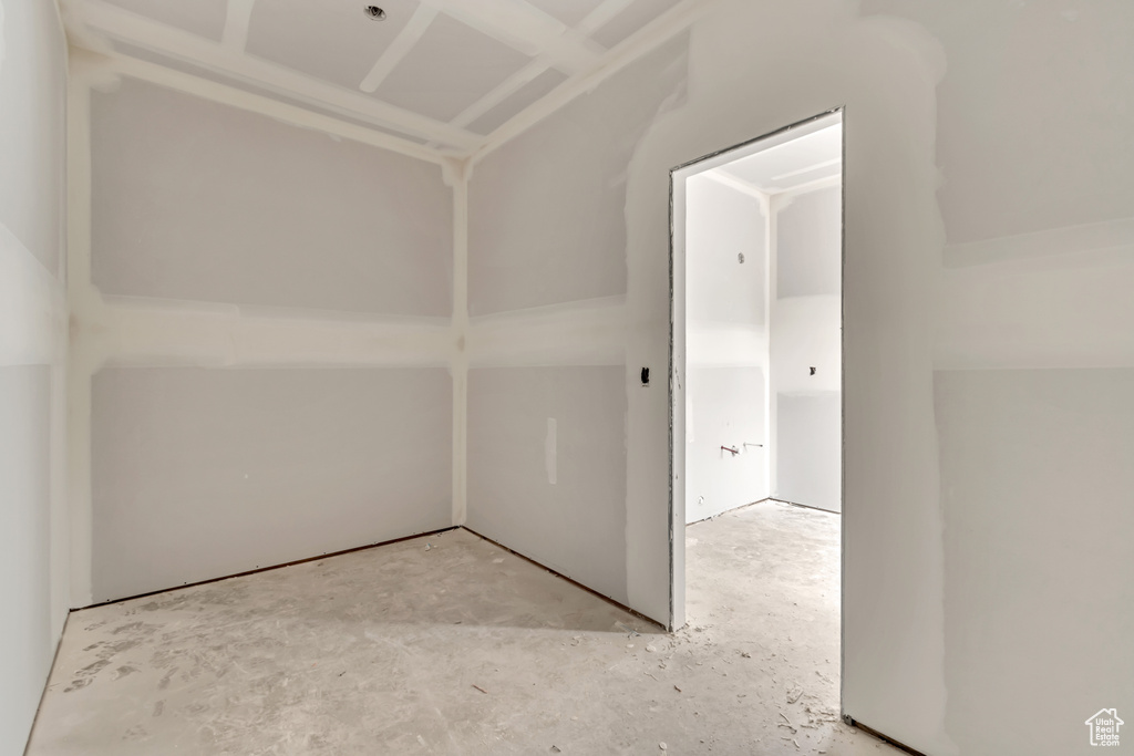 Unfurnished room featuring concrete flooring