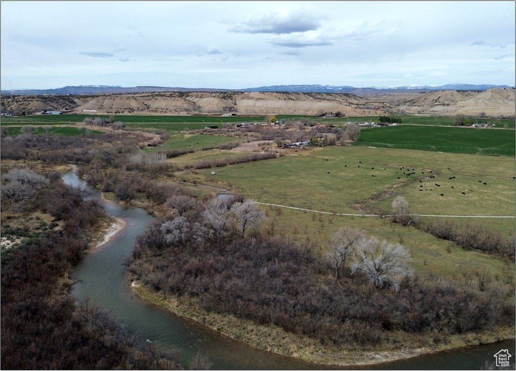 Drone / aerial view featuring a water and mountain view and a rural view