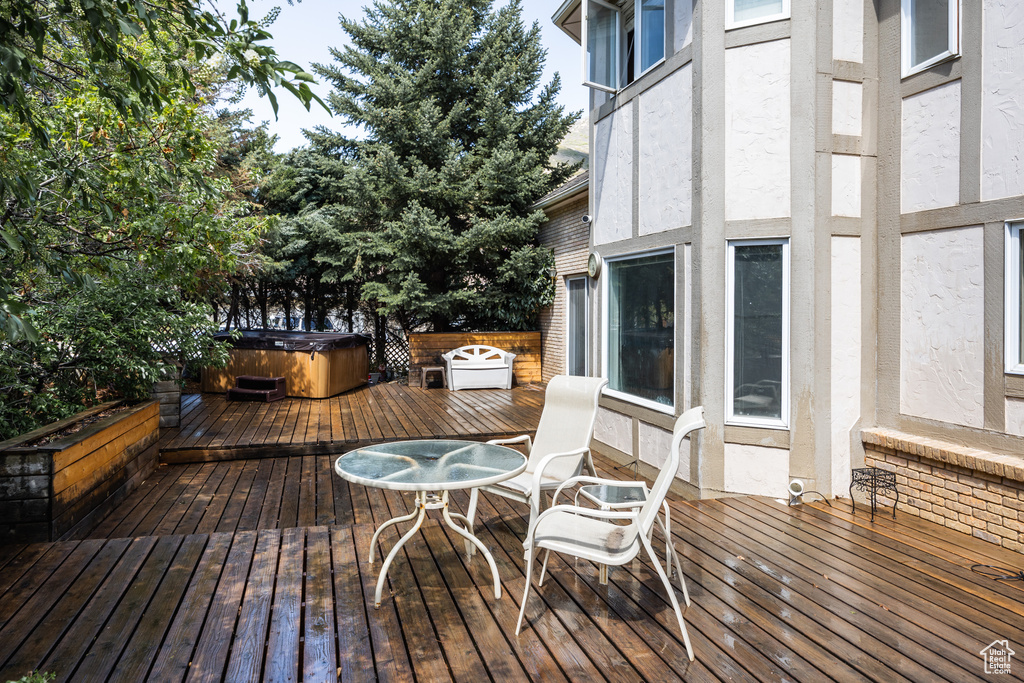 Wooden deck featuring a hot tub