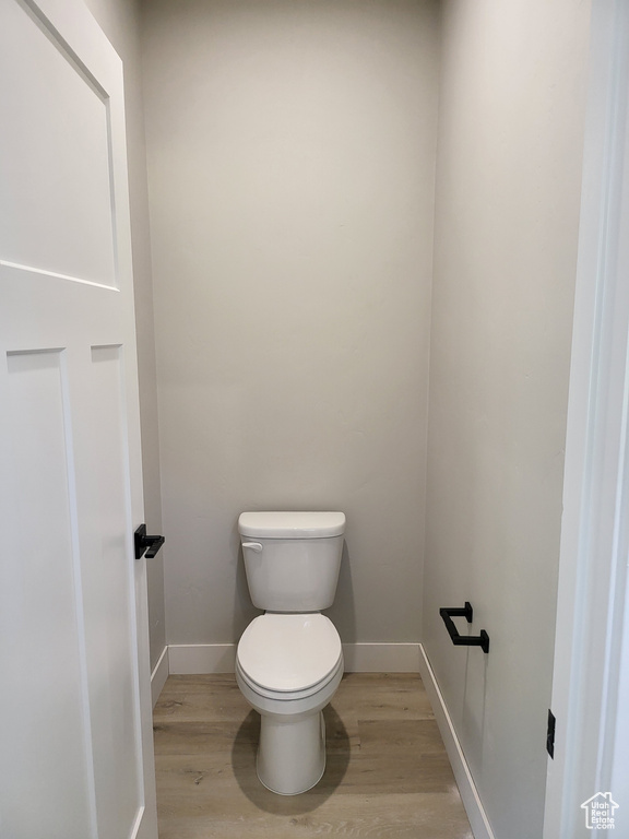 Bathroom featuring toilet and wood-type flooring