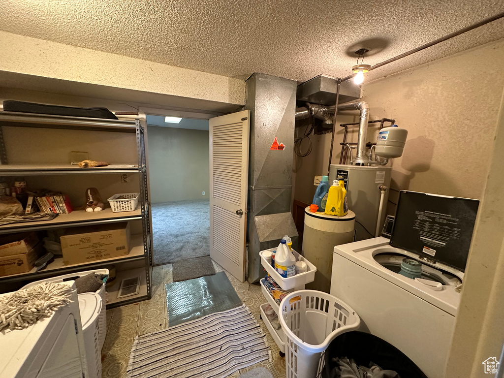Utility room featuring water heater and washer / clothes dryer