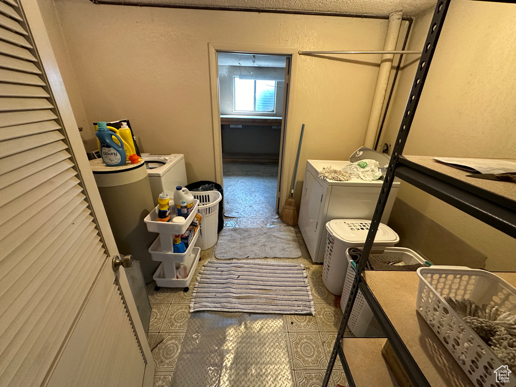 Laundry room featuring tile floors and washer and dryer