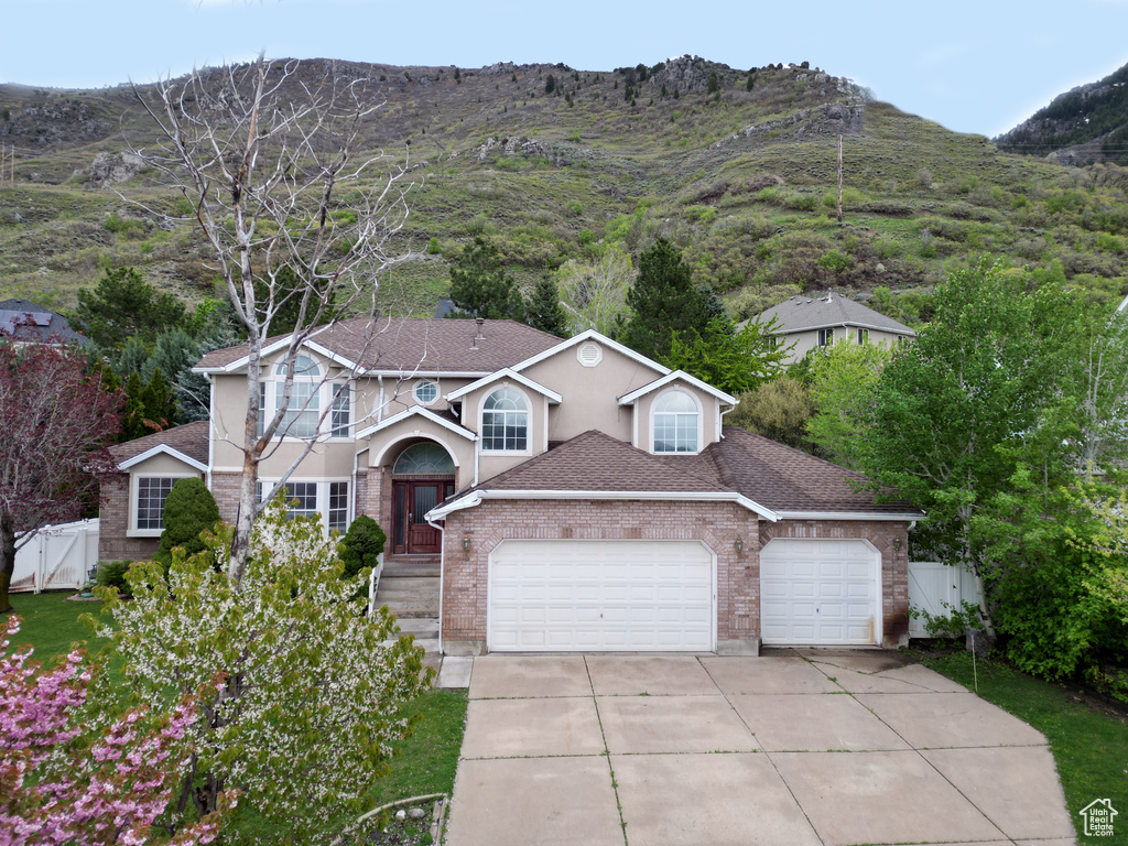 Front of property featuring a mountain view and a garage