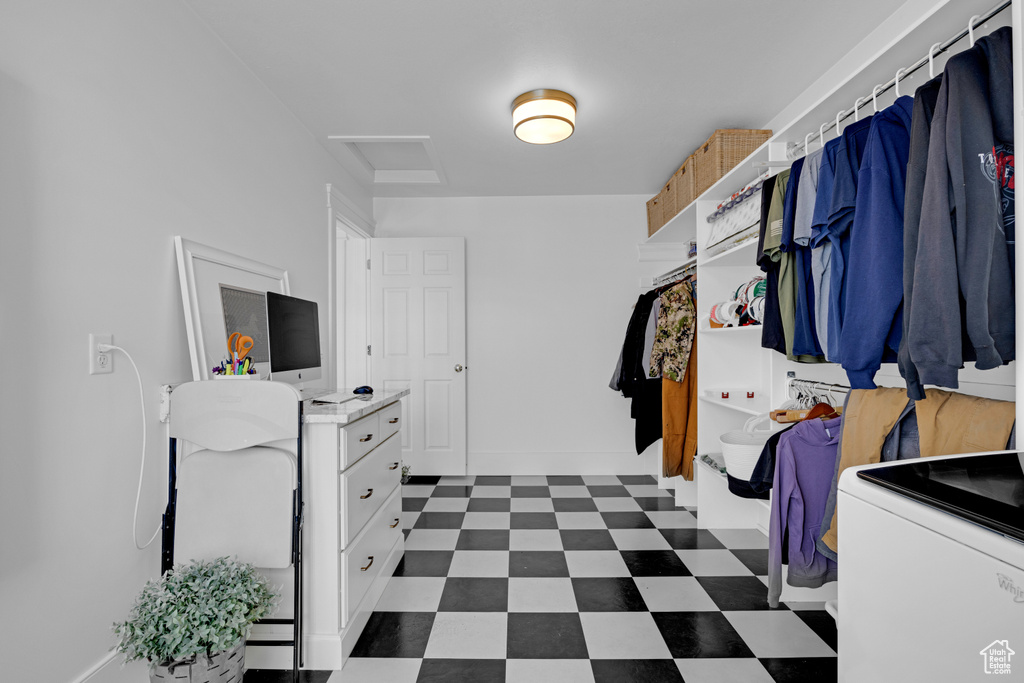 Spacious closet featuring dark tile flooring and washer / clothes dryer