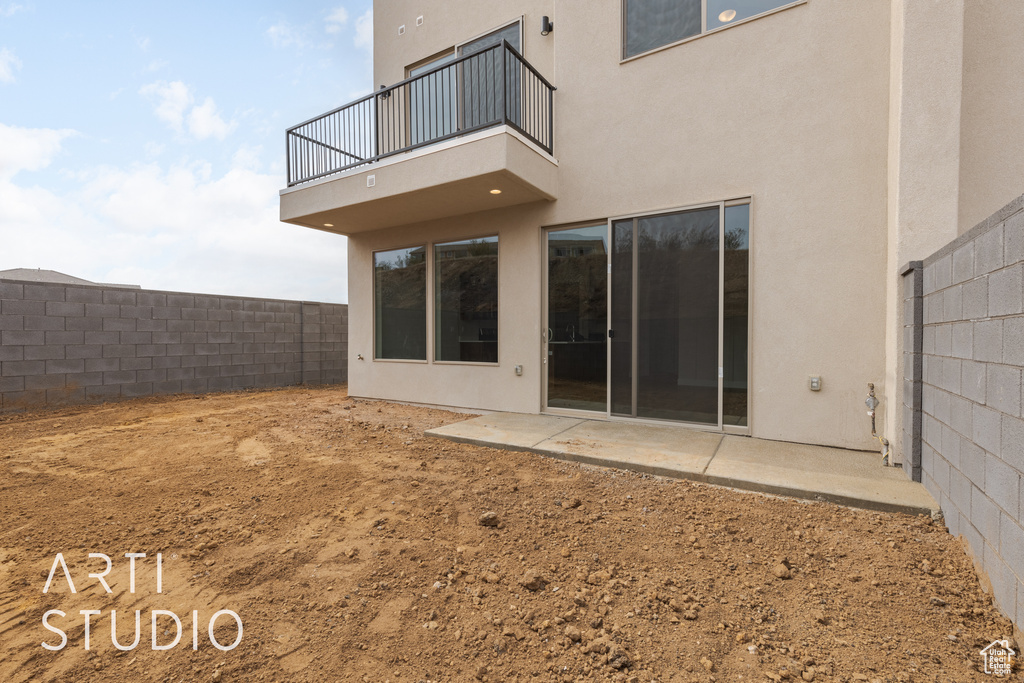 Back of property featuring a patio area and a balcony