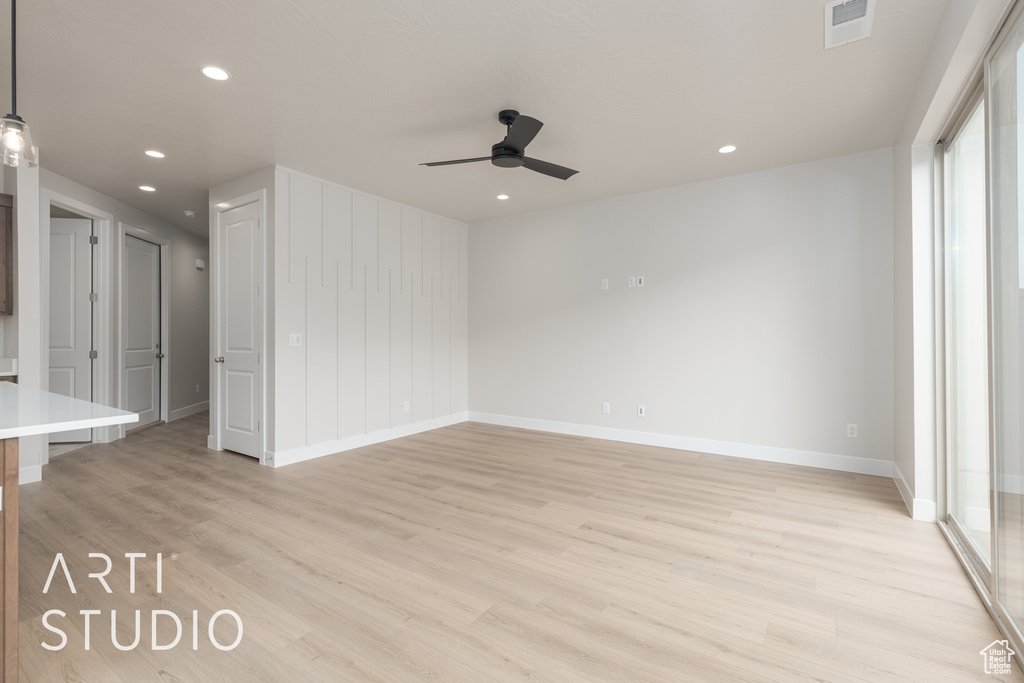 Empty room featuring ceiling fan and light hardwood / wood-style floors