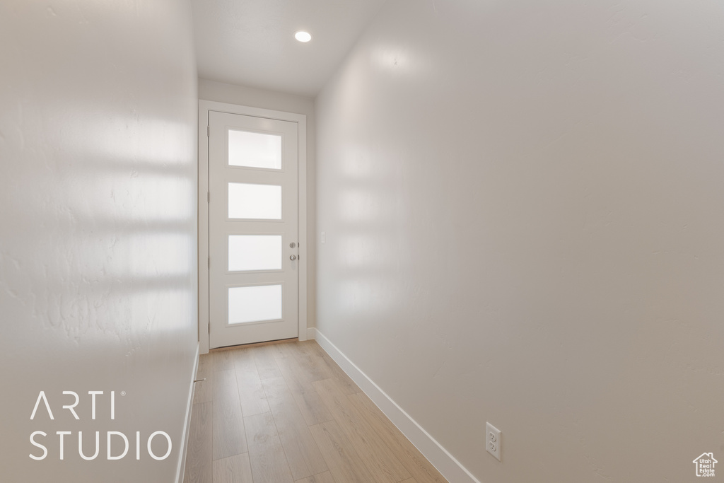 Doorway to outside featuring plenty of natural light and light wood-type flooring