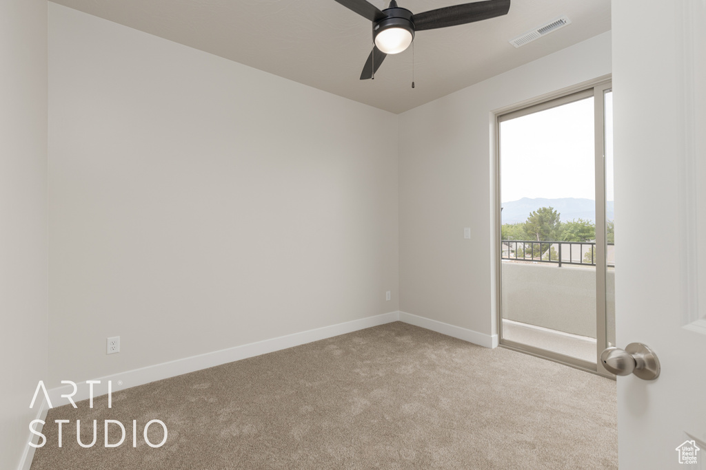 Unfurnished room featuring carpet flooring and ceiling fan