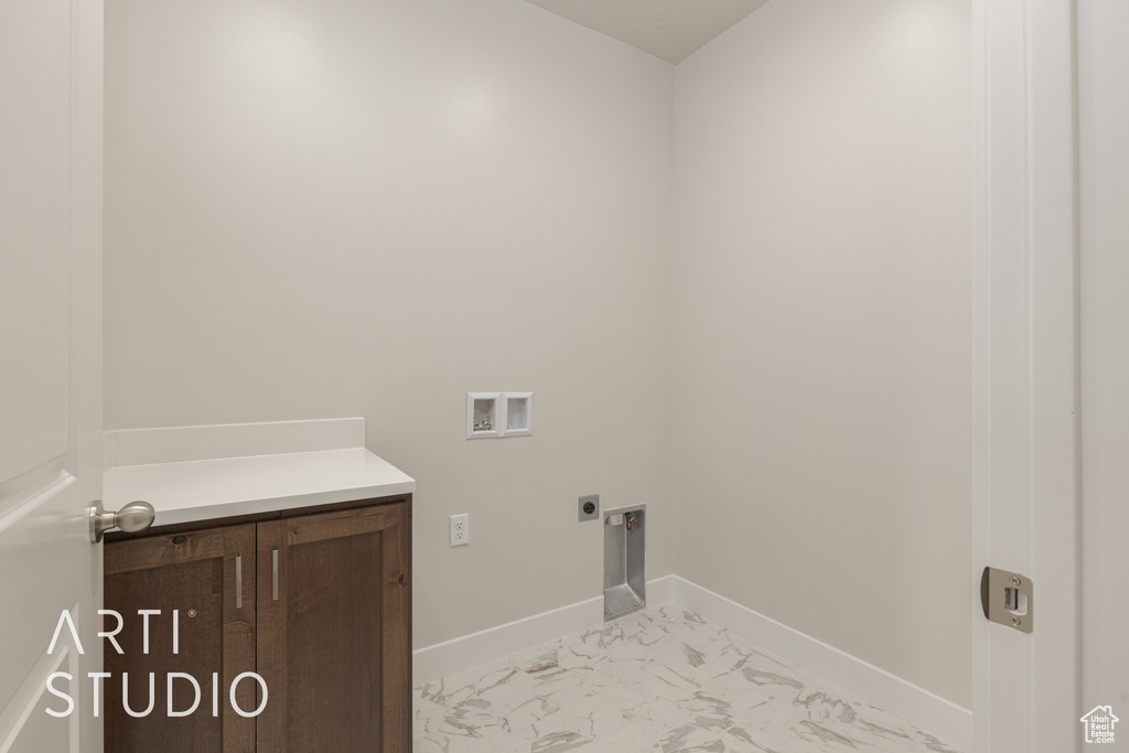 Washroom featuring hookup for a washing machine, hookup for an electric dryer, and light tile floors