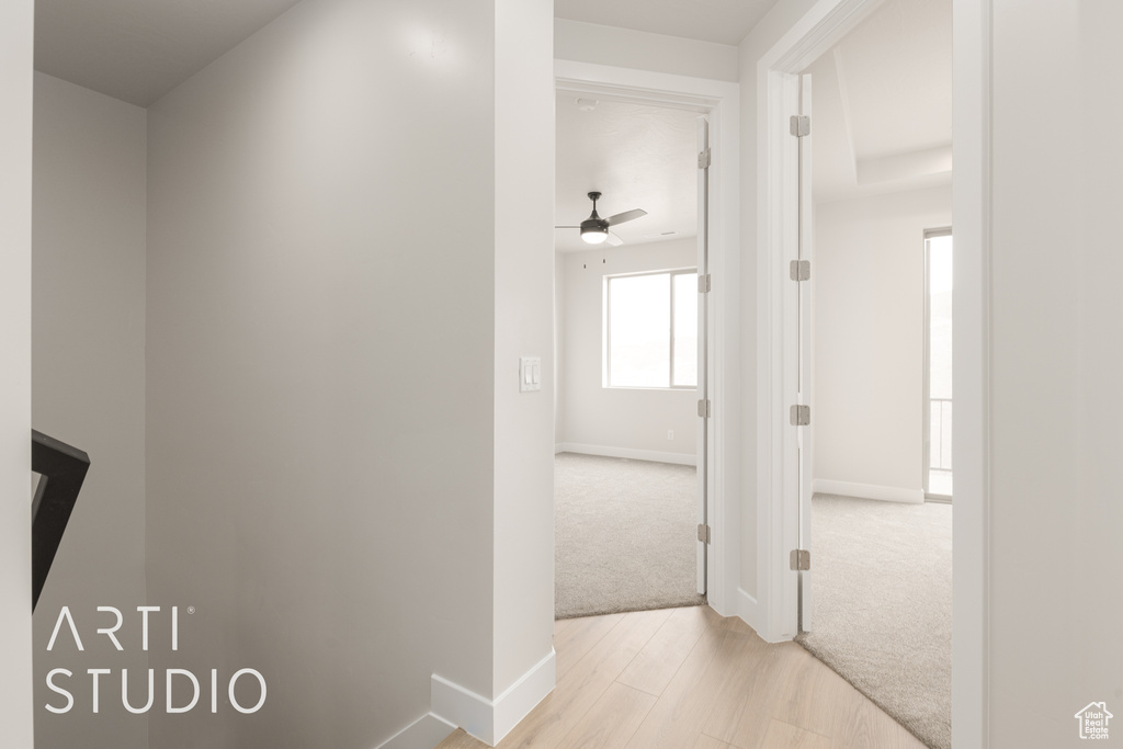 Hall with light hardwood / wood-style flooring