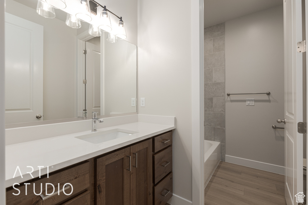 Bathroom with vanity and hardwood / wood-style floors