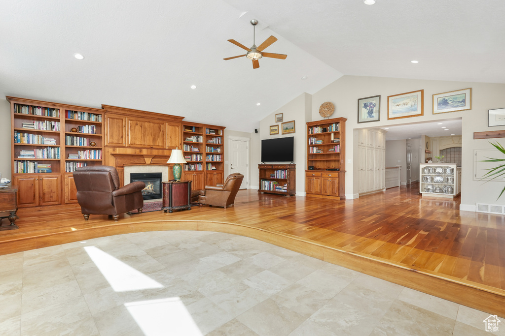 Interior space with high vaulted ceiling, ceiling fan, and light wood-type flooring