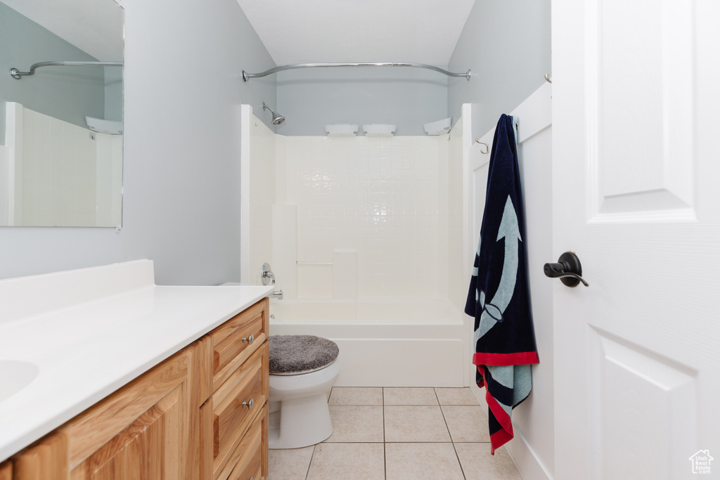 Full bathroom with vanity, tile floors, toilet, and shower / washtub combination