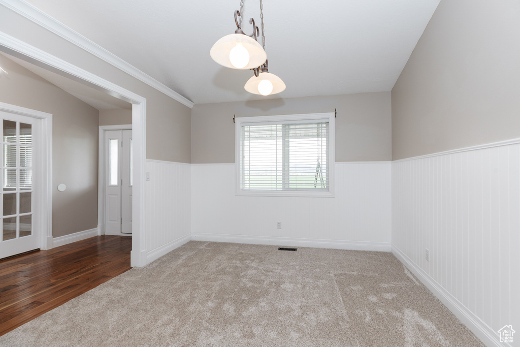 Spare room featuring hardwood / wood-style floors and ornamental molding