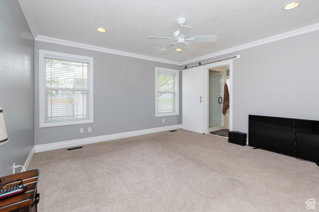 Unfurnished room with ceiling fan, crown molding, and carpet flooring