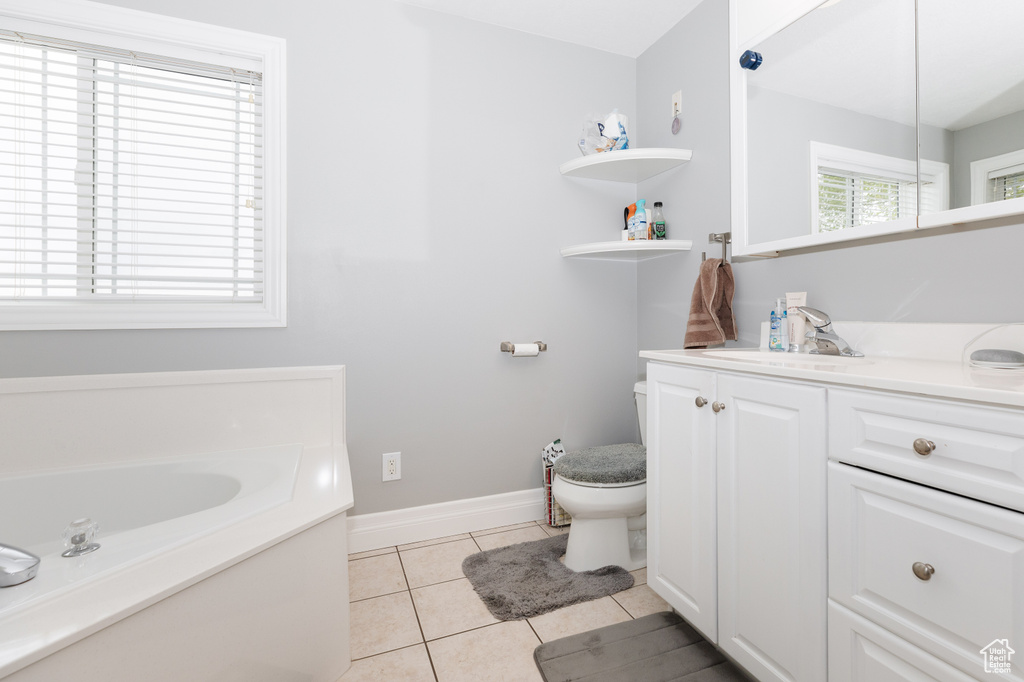 Bathroom with a washtub, tile floors, sink, and toilet