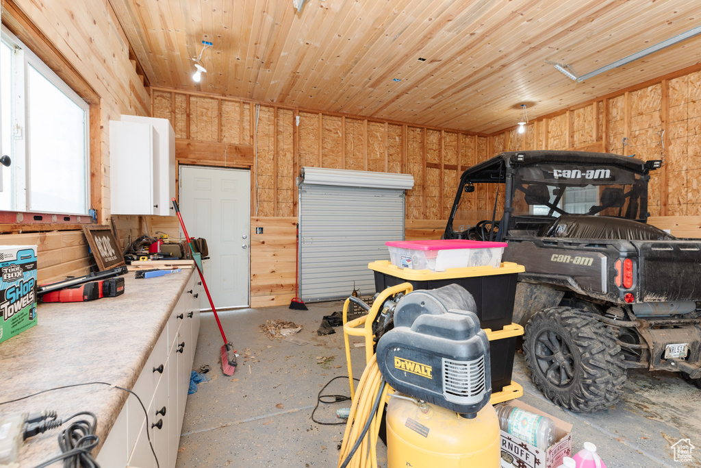 Garage with wood walls and wood ceiling