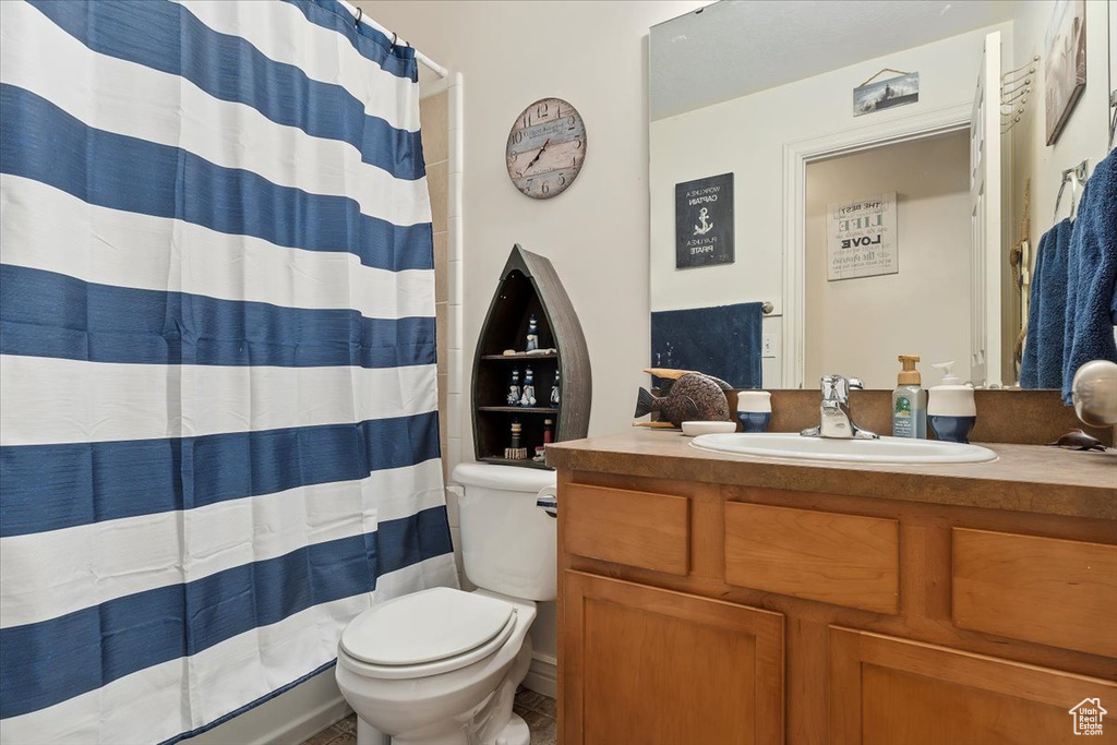 Bathroom with tile floors, vanity, and toilet