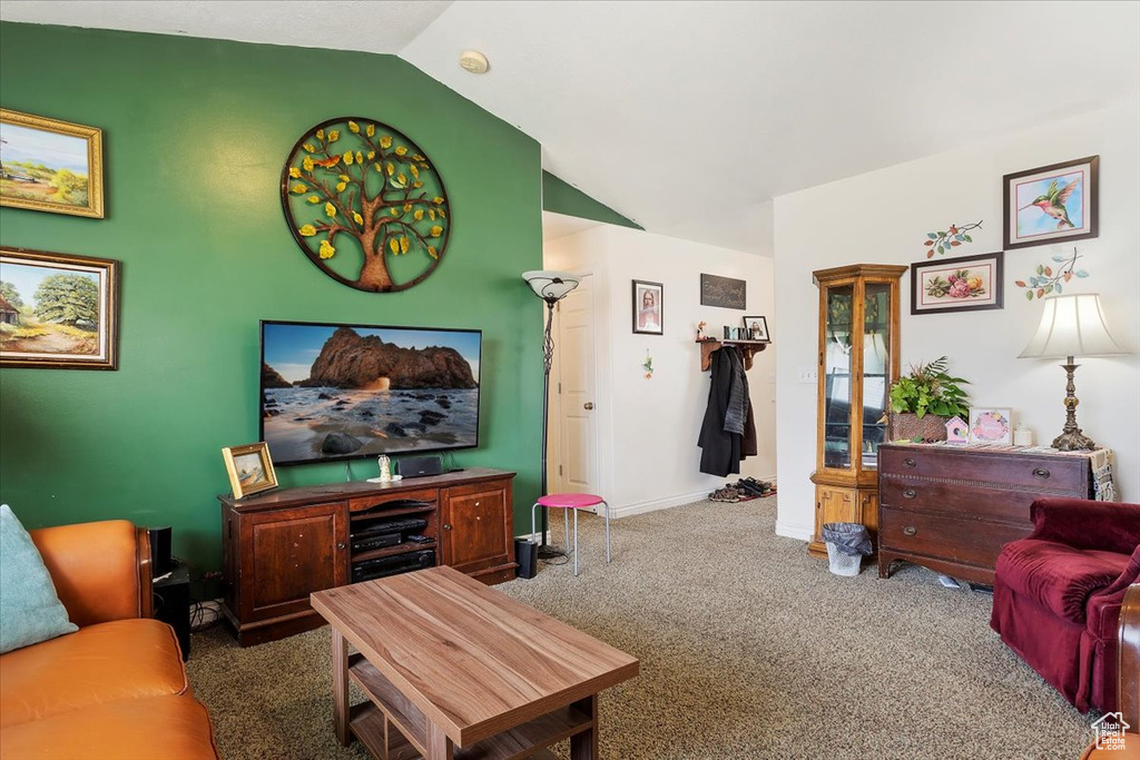 Carpeted living room with lofted ceiling