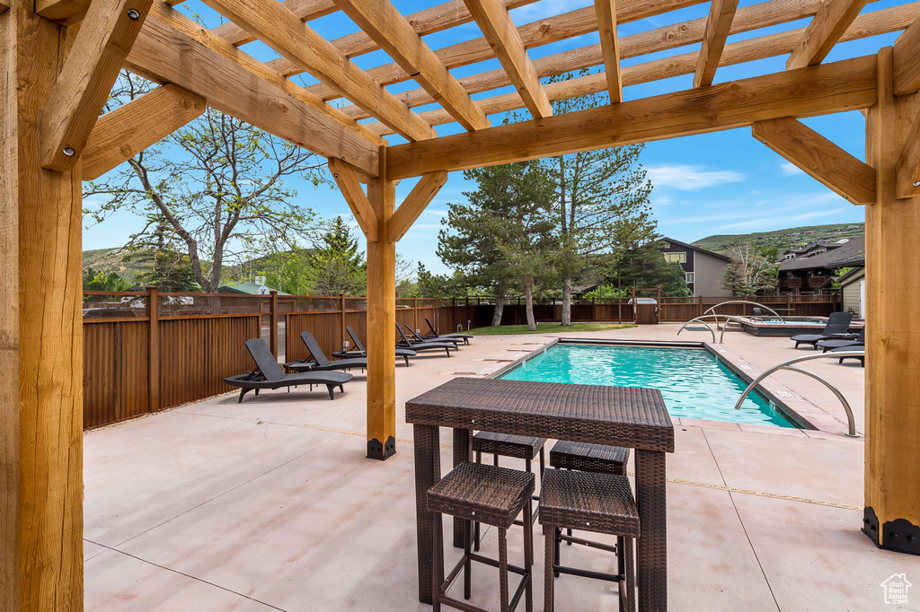 View of pool featuring a patio and a pergola