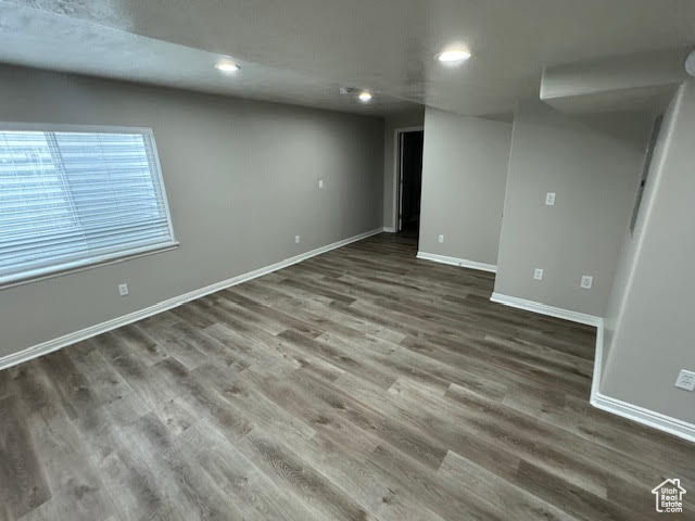 Unfurnished room featuring dark wood-type flooring