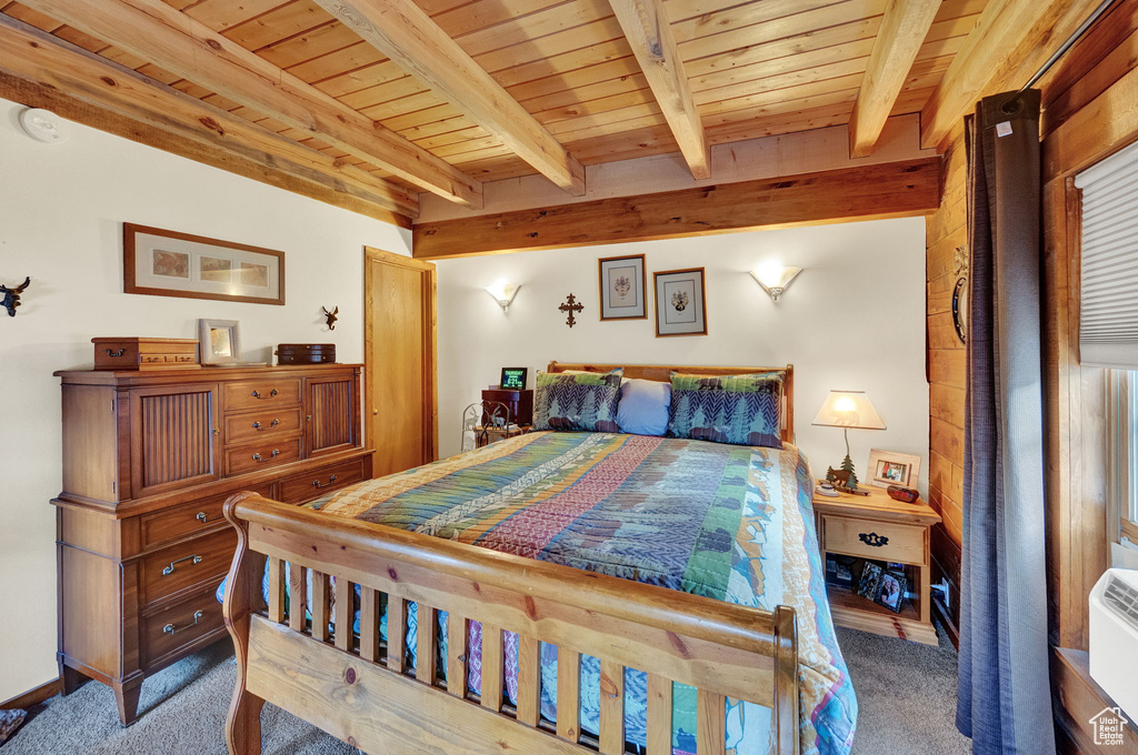 Carpeted bedroom featuring wood ceiling and beam ceiling