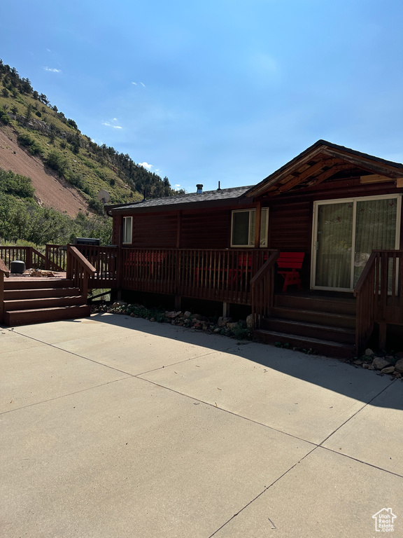 View of front of property featuring a wooden deck