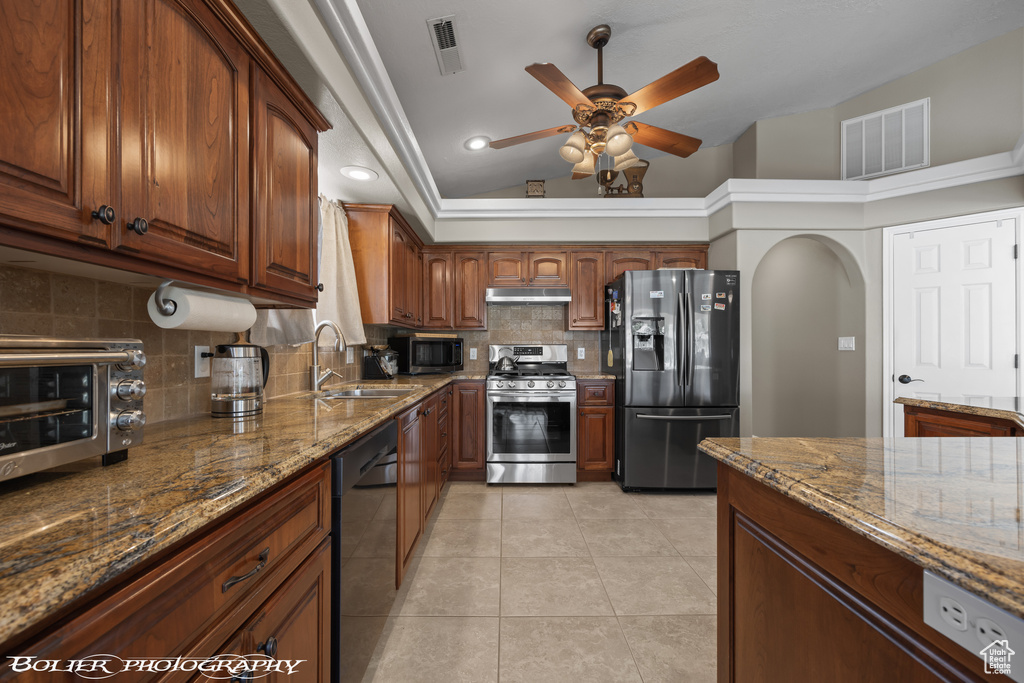 Kitchen with backsplash, ceiling fan, sink, and stainless steel appliances