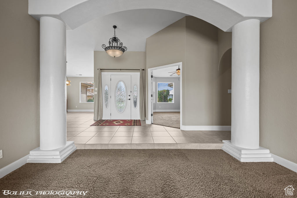 Tiled foyer with ornate columns and ceiling fan
