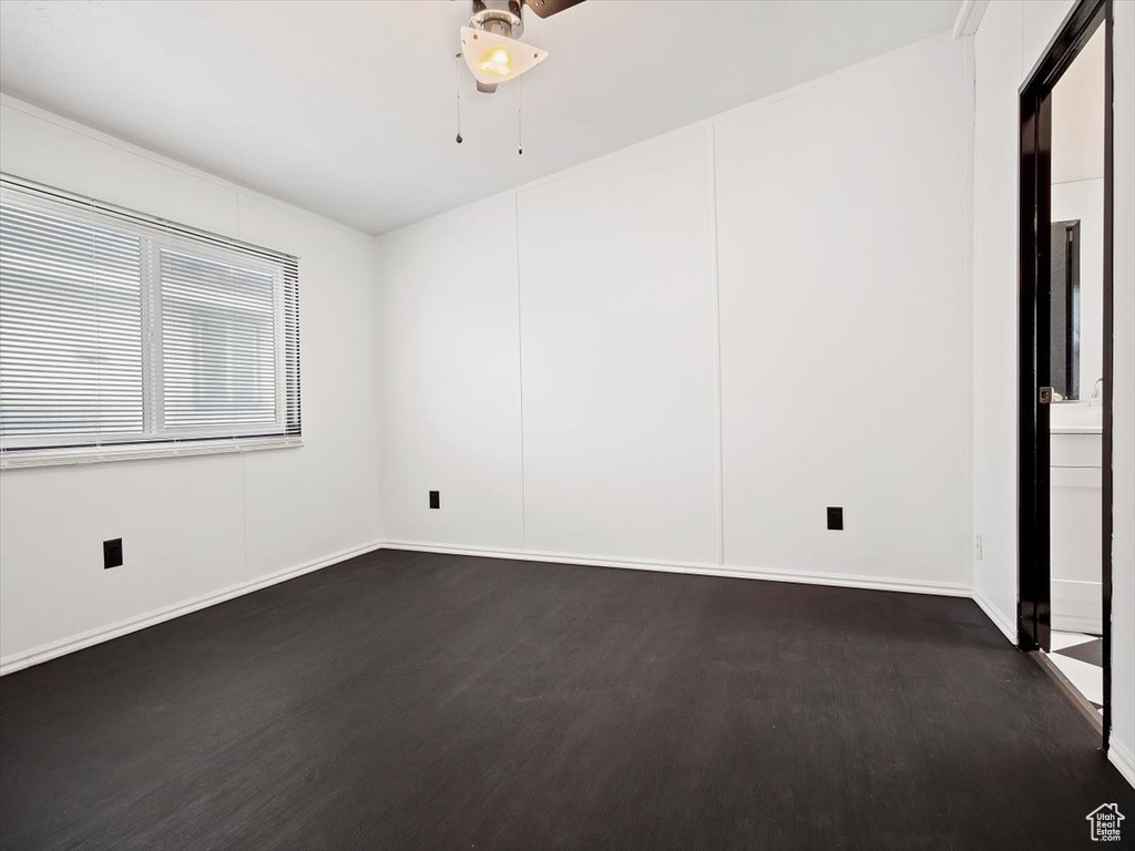 Unfurnished room with dark wood-type flooring
