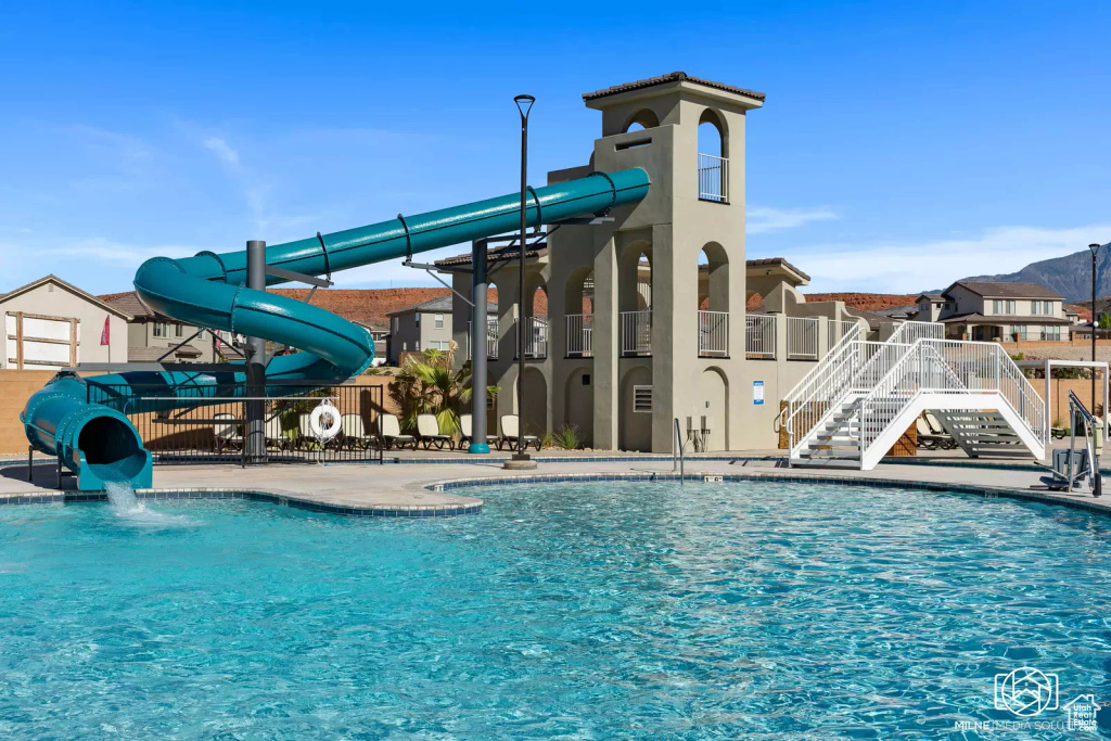 View of swimming pool featuring a water slide