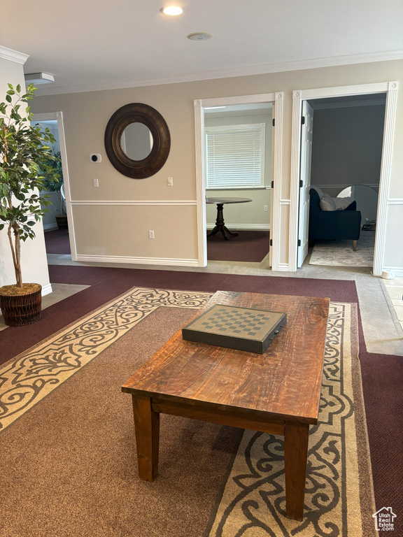 Carpeted living room with ornamental molding