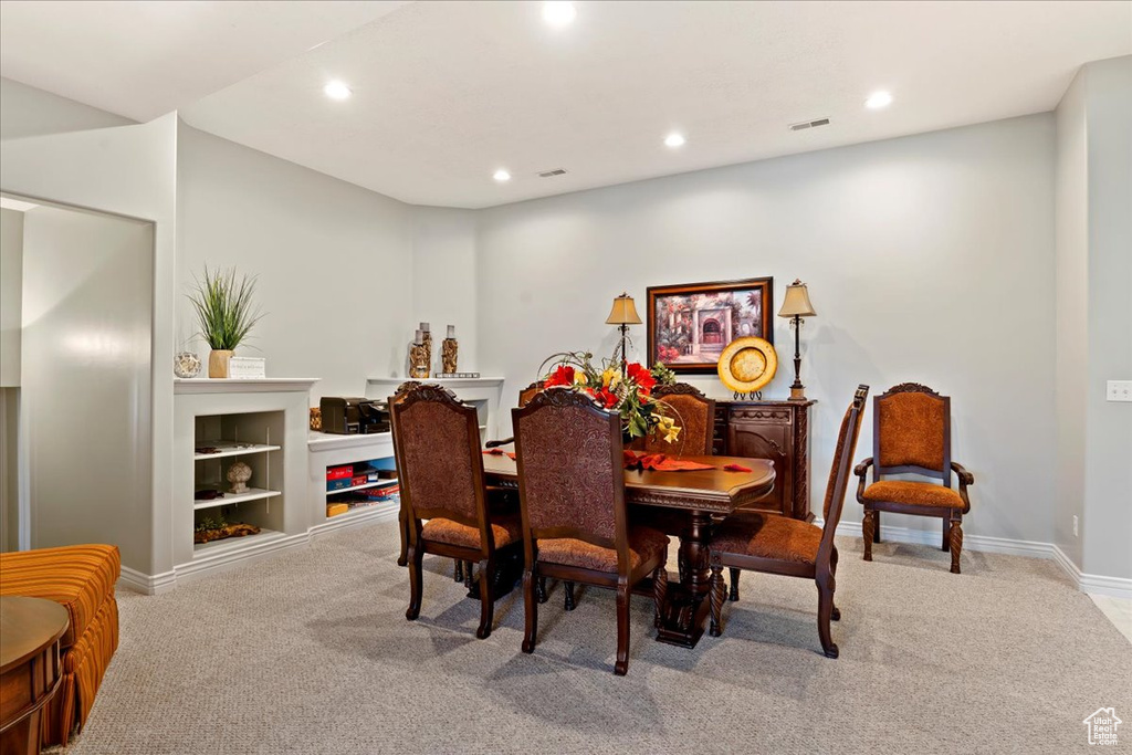 Carpeted dining room featuring built in features