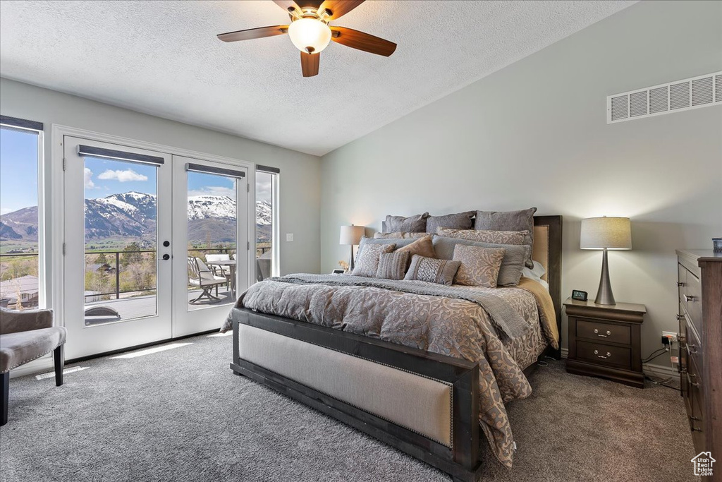 Bedroom featuring ceiling fan, carpet, a textured ceiling, access to exterior, and french doors