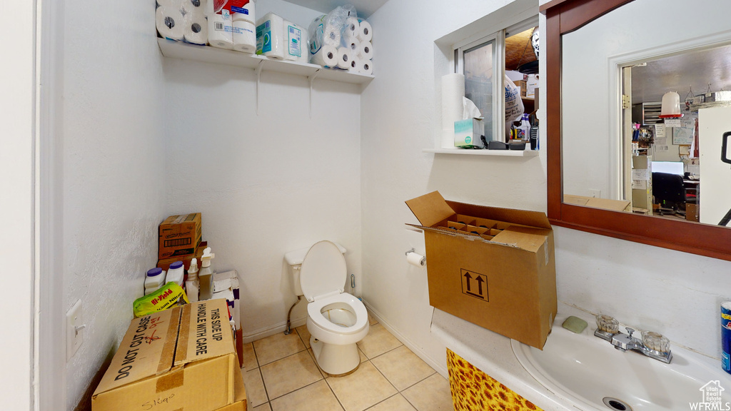 Bathroom with tile flooring, sink, and toilet