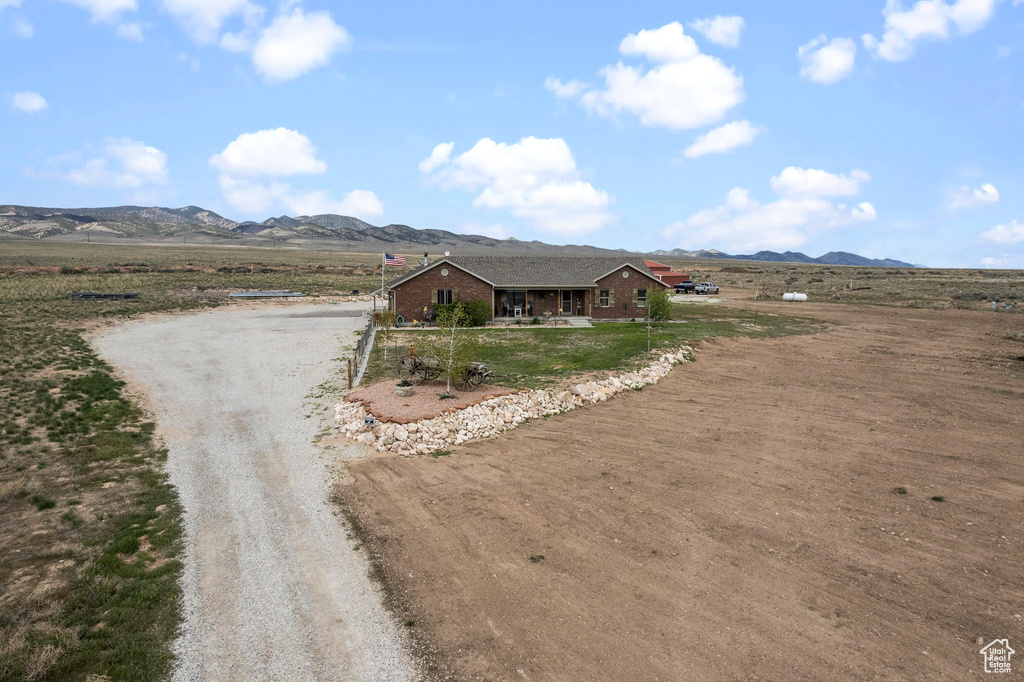 View of front of house with a mountain view and a rural view