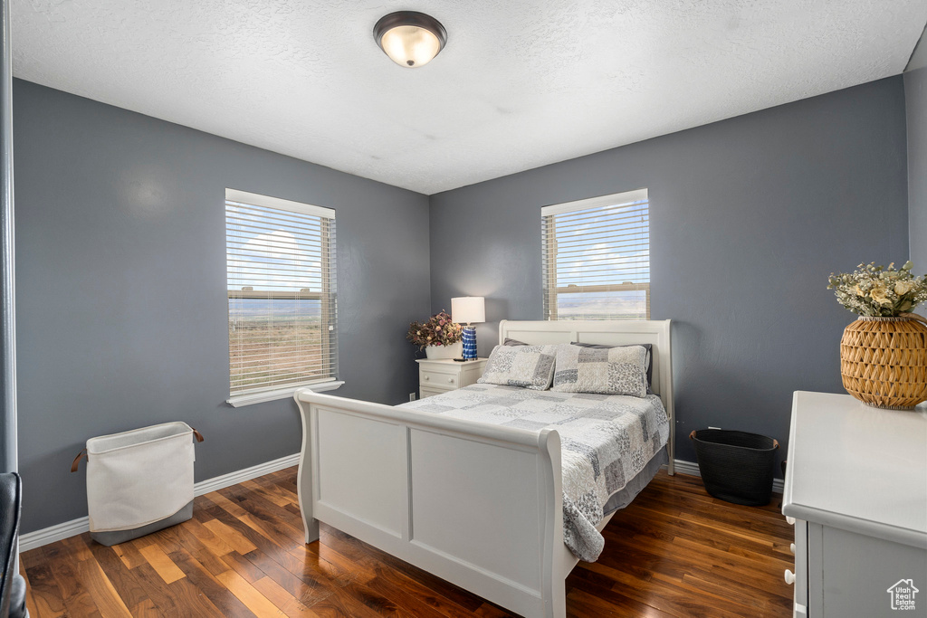 Bedroom featuring dark wood-type flooring