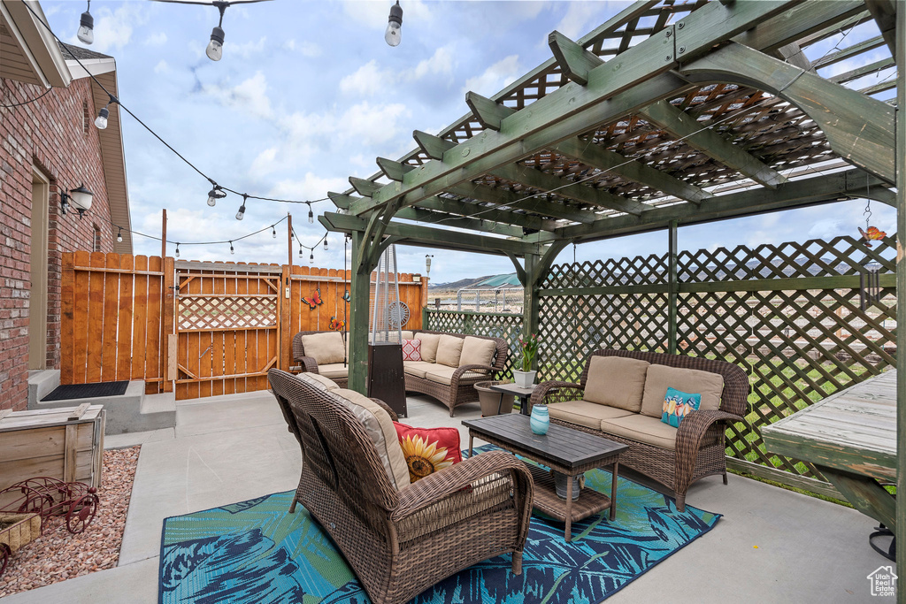 View of patio with an outdoor living space and a pergola