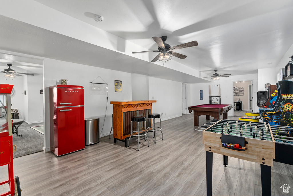 Recreation room with ceiling fan, hardwood / wood-style flooring, and billiards