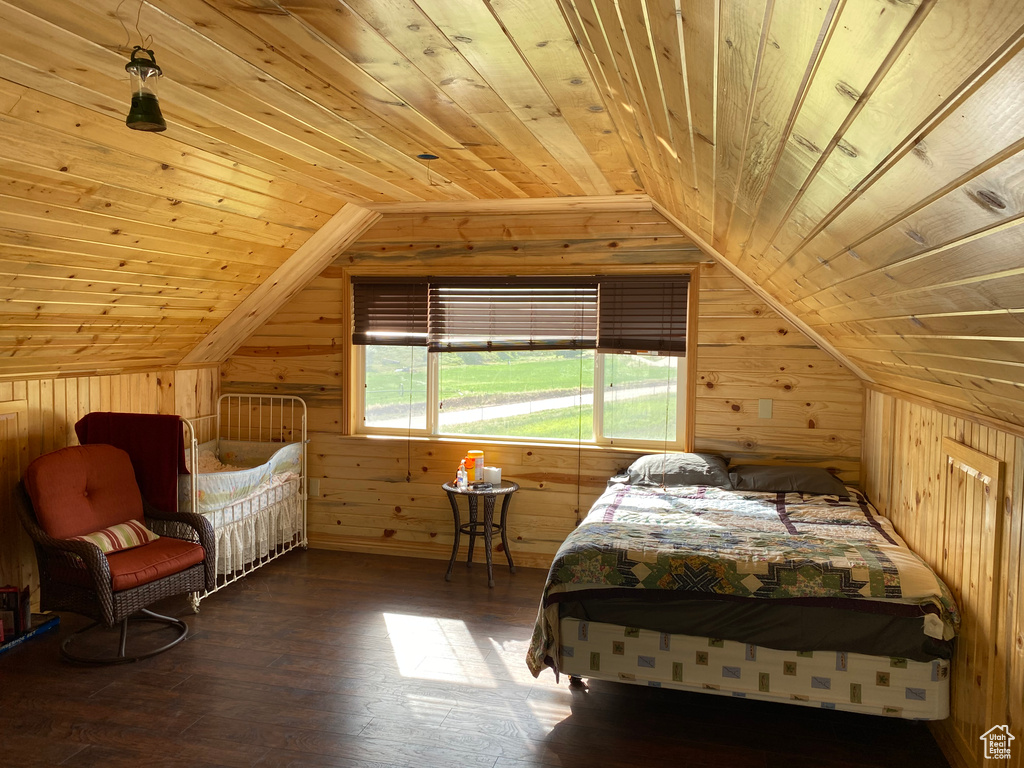 Bedroom featuring wood-type flooring, wood ceiling, wood walls, and vaulted ceiling